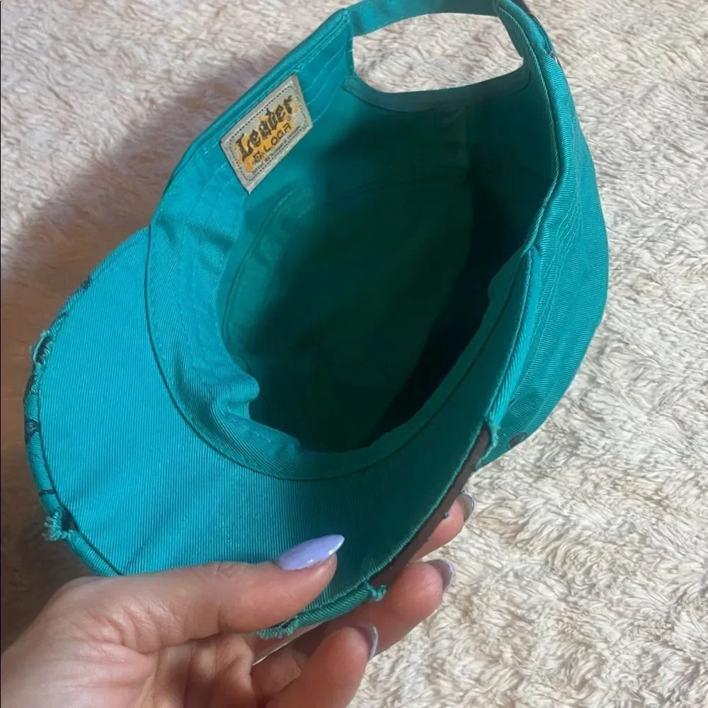 Teal Cap with Green Cross Design